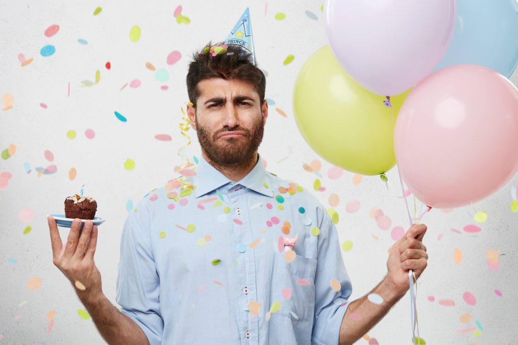 Skeptical beardy stock-photo man at a lame party.